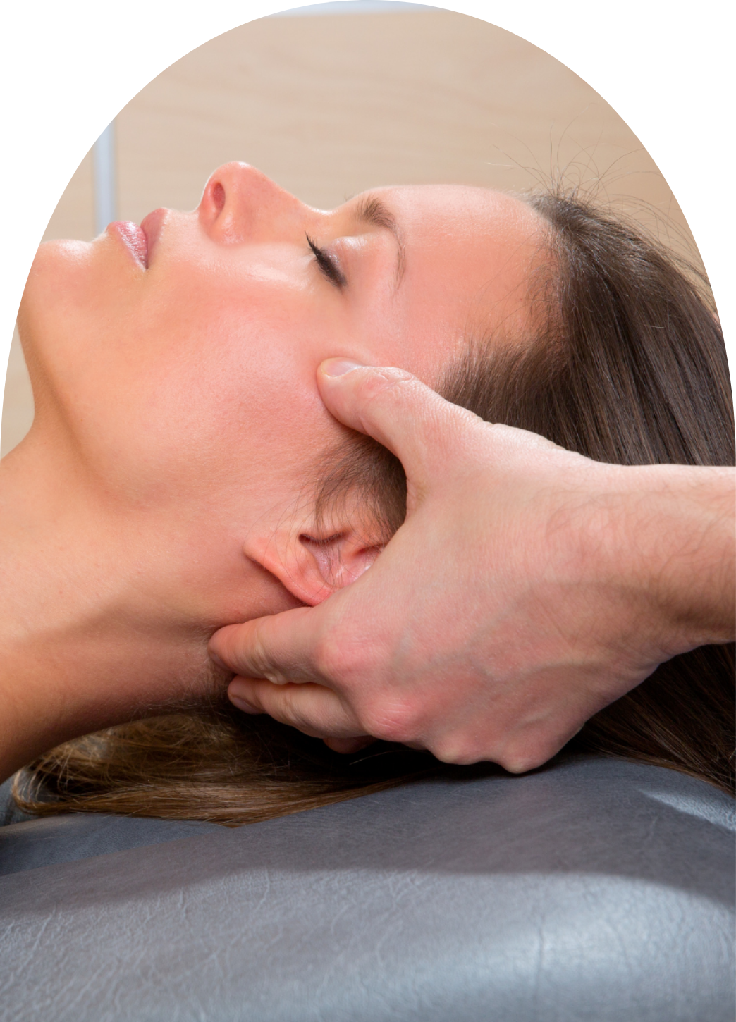 A woman receiving facial reflexology treatment